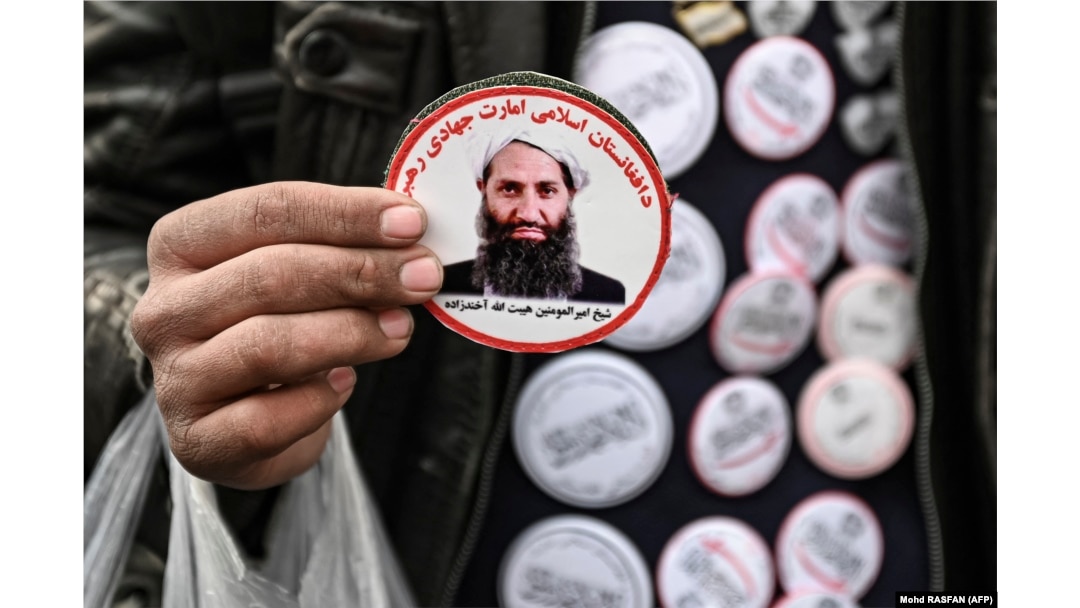 A man sells stickers depicting Taliban Supreme Leader Haibatullah Akhundzada at market in Kabul.
