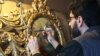 The painter Haik Azarian restores an old icon from the Armenian Church in Botoșani, in his studio in Bucharest.