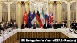 EU envoy Enrique Mora and Iran's chief nuclear negotiator, Ali Bagheri Kani, and their delegations wait for the start of a meeting of the JCPOA Joint Commission in Vienna on December 17.