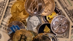 Representations of virtual cryptocurrencies are placed on U.S. Dollar banknotes in this illustration