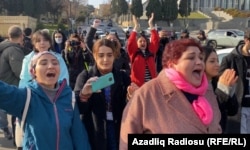 A group of journalists gathered outside Azerbaijan's parliament in Baku on December 28 protest a new media law that they say will further limit independent journalism in the country.