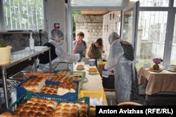 People wait to receive free food in Kharkiv.