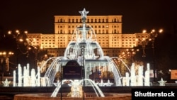 Christmas lights and decorations adorn the Alexandru Ioan Cuza fountain in front of Romania's Palace of the Parliament in downtown Bucharest. (file photo)