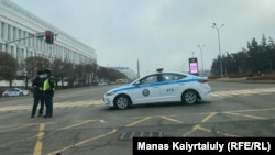 Kazakh police guard Almaty's Republic Square on December 16.