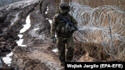  A Polish soldier patrols the Polish-Belarusian border near Czeremcha village in eastern Poland.