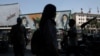 People walk past a mural depicting the late leader of the Islamic Revolution, Ayatollah Ruhollah Khomeini, and the late Iran's Supreme Leader Ayatollah Ali Khamenei, on a street in Tehran