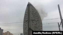 Smoke billows from the 33-floor hotel and condominium tower, one of the tallest buildings in Baku.