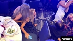 Guests take cover after shots rang out around the ballroom.