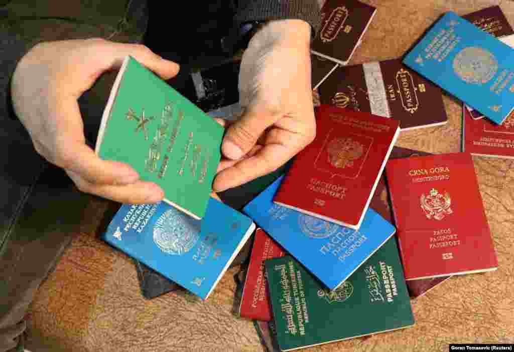 A Kurdish official shows the passports of captured Islamic State suspects in Rimelan, Syria.