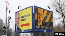 Dueling billboards for parliament speaker Volodymyr Lytvyn (left) and former Foreign Minister Arseniy Yatsenyuk in downtown Kyiv.