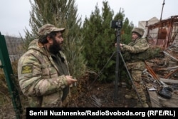 Illya Lif watches a soldier preparing a transmission device for an FPV drone in the Donetsk region of Ukraine.