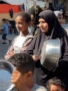 AFP - NUSEIRAT - GAZA - PALESTINIAN TERRITORIES - Gazans banging on their empty pots