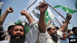 Pakistani activists of the hard-line organisation Jamaat-ud-Dawa (JuD) shout anti-India slogans during a protest against the arrival of Indian Home Minister Rajnath Singh, in Peshawar on August 3.