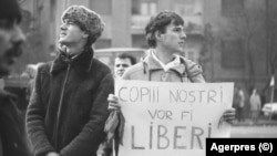 Doi prieteni printre demonstranții de pe Bulevardul Magheru din București, în apropiere de Piața Romană, 22 Decembrie 1989.