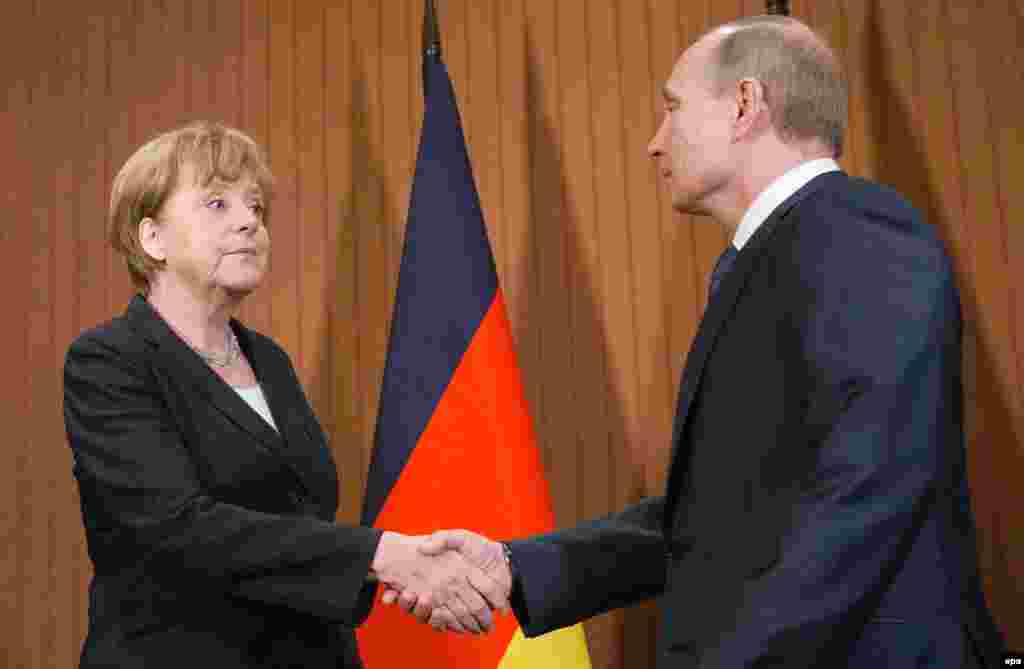 Russian President Vladimir Putin meets with German Chancellor Angela Merkel in Deauville, France on June 6, 2014.