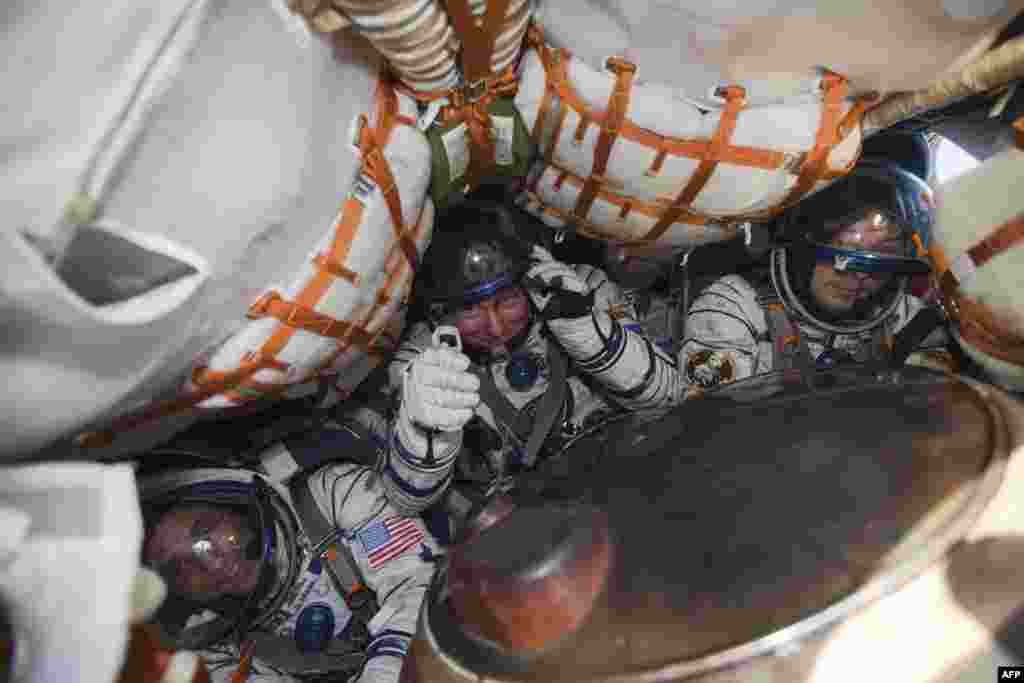 U.S. astronaut Joseph Acaba (left) and Russian cosmonauts Gennady Padalka (center) and Sergei Revin are shown crammed inside the tiny Soyuz capsule shortly after landing.