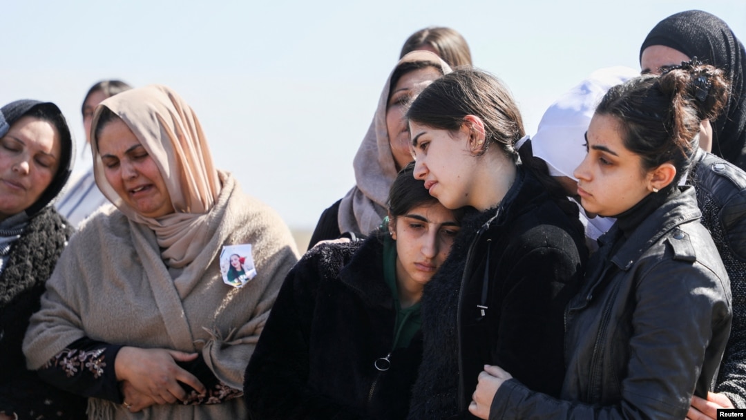 Mourners react during the funeral of Kurdish medical student Shinda Kisho, who was killed in Latakia, March 9