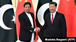 Chinese President Xi Jinping (right) shakes hands with Pakistani Prime Minister Imran Khan before a meeting at the Great Hall of the People in Beijing in April 2019.