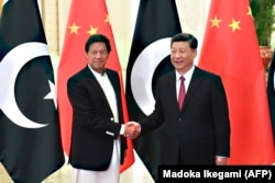 Пәкістан премьер-министрі Имран Хан (сол жақта) Қытай президенті Си Цзиньпинмен бірге. 2019 жыл.