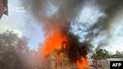 A Ukrainian Academy of Sciences building in central Kyiv burns after a Russian drone strike on September 28