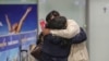 A couple hugs after the first wave of evacuees from Kabul arrived at Frankfurt International Airport in Germany on August 18.