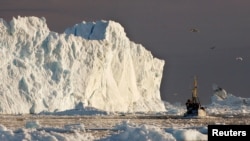 Ribarski brod plovi pored velikog ledenjaka, fjord Jakobshavns, Grenland 