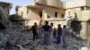 Men inspect the debris of houses after an apparent air strike by the Iraqi Air Force in Fallujah on September 1.