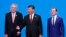Czech President Milos Zeman (left), Chinese President Xi Jinping (center), and Russian Prime Minister Dmitry Medvedev (right) pose at the China International Import Expo in Shanghai.