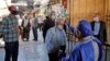 An Iranian official checks the temperature of visitors at the Shah Abdol-Azim shrine in the capital Tehran, May 25, 2020