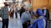 An Iranian official checks the temperature of visitors at the Shah Abdol-Azim shrine in the capital, Tehran, on May 25.