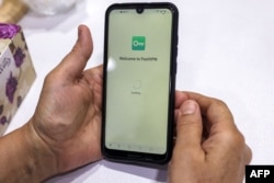 An Iranian holds a phone after activating a virtual private network (VPN) service to access the Internet in Tehran in 2023.
