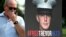 Joey Reed, the father of former U.S. Marine Trevor Reed, stands next to a placard of his son outside the U.S. Capitol in Washington in July.