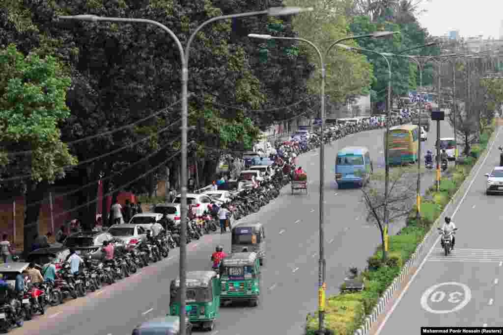 Cars and motorcycles form a long line outside a fuel station in Dhaka, Bangladesh, on April 6. Shortages in the country have been blamed on "panic buying" amid uncertainty over fuel supplies to Bangladesh.