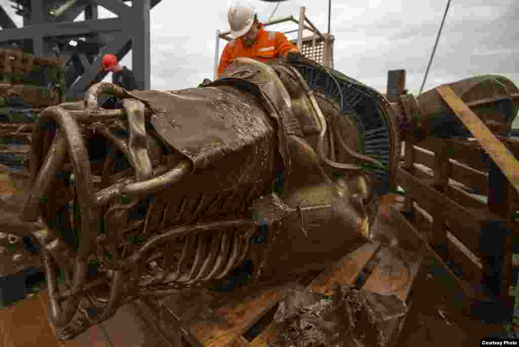 A heat exchanger from an Apollo spacecraft on the deck of the "Seabed Worker" after it and other engine parts were retrieved from the seabed of the Atlantic Ocean. (Bezos Expeditions)