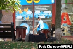 A homeless man sleeps on the street in Kyiv on September 3.