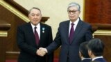 KAZAKHSTAN -- Acting Kazakh President Qasym-Zhomart Toqaev and outgoing Kazakh President Nursultan Nazarbaev shake hands after an inauguration ceremony in Astana, March 20, 2019