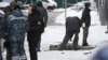 Investigators and police experts work by a body at the scene of a blast in Moscow that killed a senior Russian general and his assistant on December 17. 