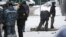 Investigators and police experts work by a body at the scene of a blast in Moscow that killed a senior Russian general and his assistant on December 17. 