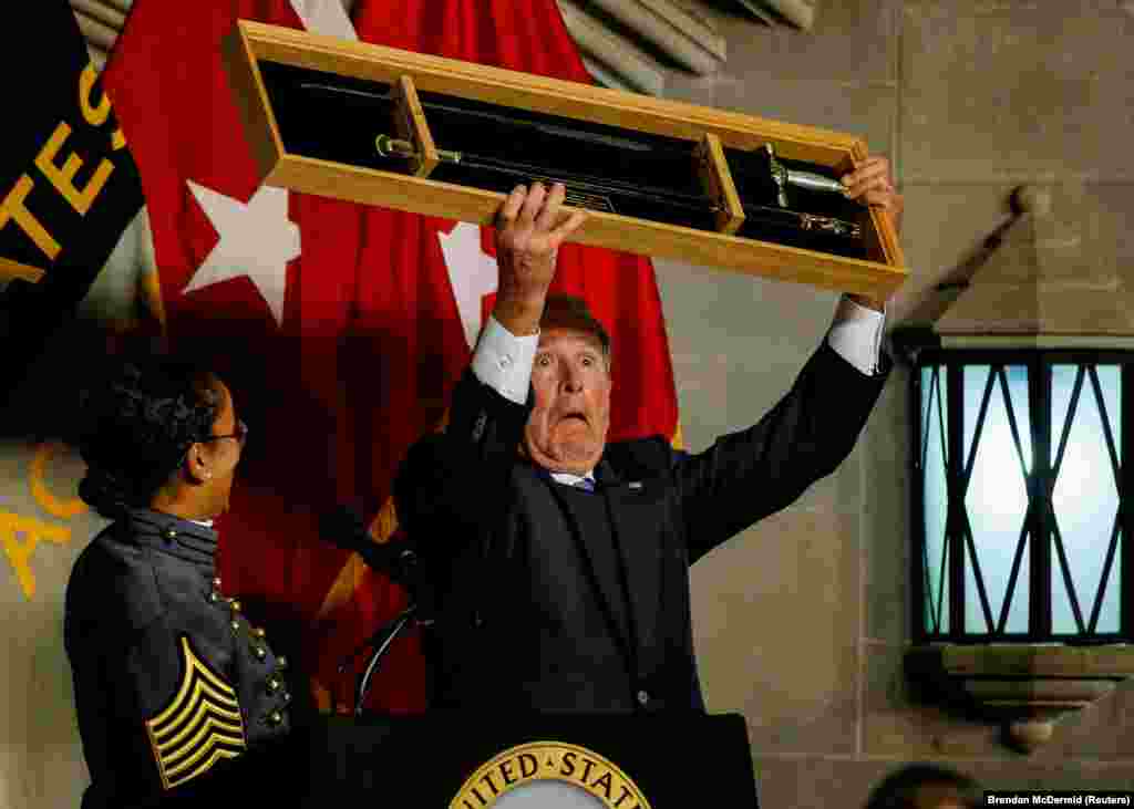 Former U.S. President George W. Bush is presented with a cadets' sword as he is honored with the Sylvanus Thayer Award at the U.S. Military Academy at West Point, New York. (Reuters/Brendan McDermid)