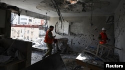 Israeli soldiers inspect the remains of an apartment that was struck in a deadly Iranian missile attack in Ramat Gan, outside Tel Aviv, on March 18.