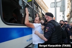 A Russian police officer detains a demonstrator during a protest in central Moscow earlier this year.