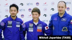 Cosmonaut Aleksandr Misurkin (right), Japanese billionaire Yusaku Maezawa (center), and his assistant, Japanese film producer Yozo Hirano (left) are seen after a training session for their flight to the ISS.