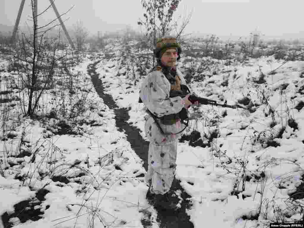 Боєць між двома позиціями на передовій