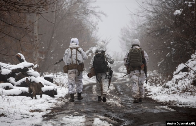 Ukrainian soldiers walk along the line of separation from pro-Russia separatists in the Donetsk region.