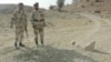 Pakistani paramilitary soldiers guard the site of a landmine blast planted by alleged Baluch nationalists in the Dera Bugti region in 2006.