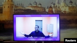 Russia - Russian opposition leader Alexei Navalny is seen on a screen via a video link during a court hearing to consider an appeal on his arrest outside Moscow, Russia January 28, 2021.