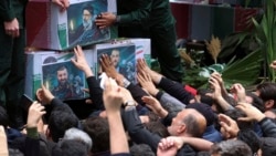 Mourners try to touch the flag-draped caskets of President Ebrahim Raisi, Foreign Minister Hossein Amir-Abdollahian, and Raisi's chief bodyguard, Mehdi Mousavi, during a funeral ceremony in the city of Tabriz, Iran, on May 21. 