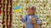 A child stands by thousands of stuffed teddy bears symbolizing Russian abductions of Ukrainian children during a demonstration in Washington, D.C. on April 23.