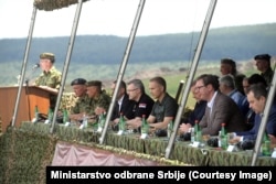 Serbian President Aleksandar Vucic (second from right) watches the Lightning Strike military exercises in Sjenica on June 27.
