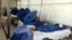 Schoolgirls receive first aid after inhaling a mysterious poisonous gas in Takhar in late May.